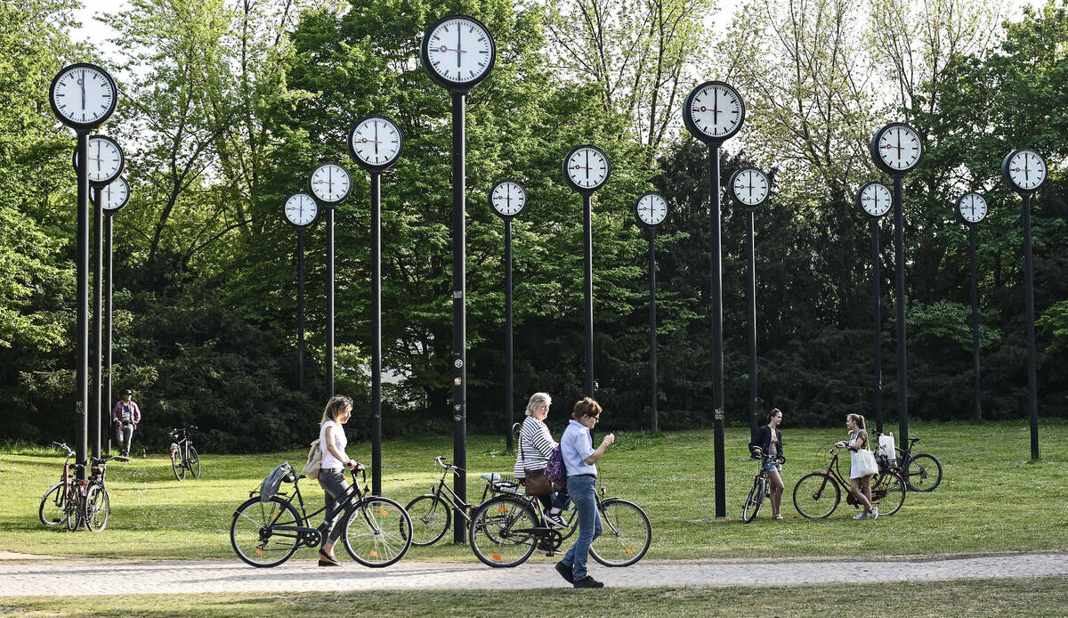 People with bicycles meet at the clock park in Duesseldorf, Germany, Friday, April 24, 2020. On ...