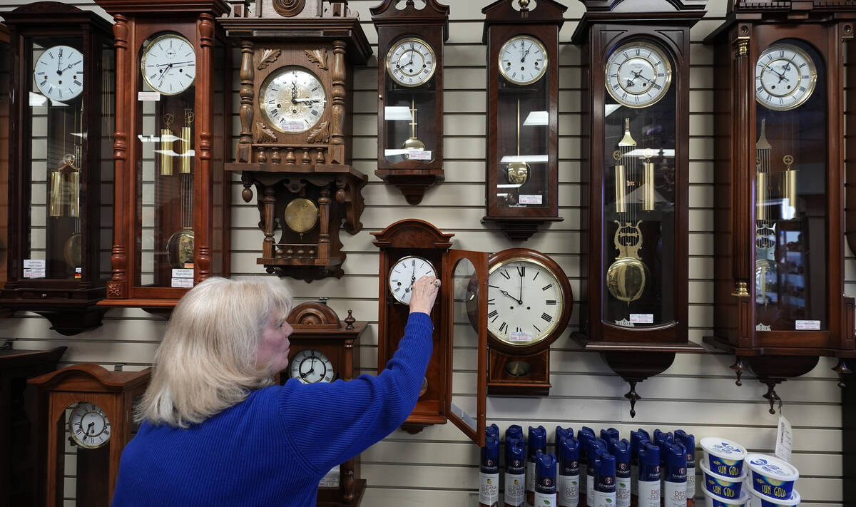 Glenda Marchesoni, owner of Heritage House Clocks, winds a clock at her shop Tuesday, March 5, ...