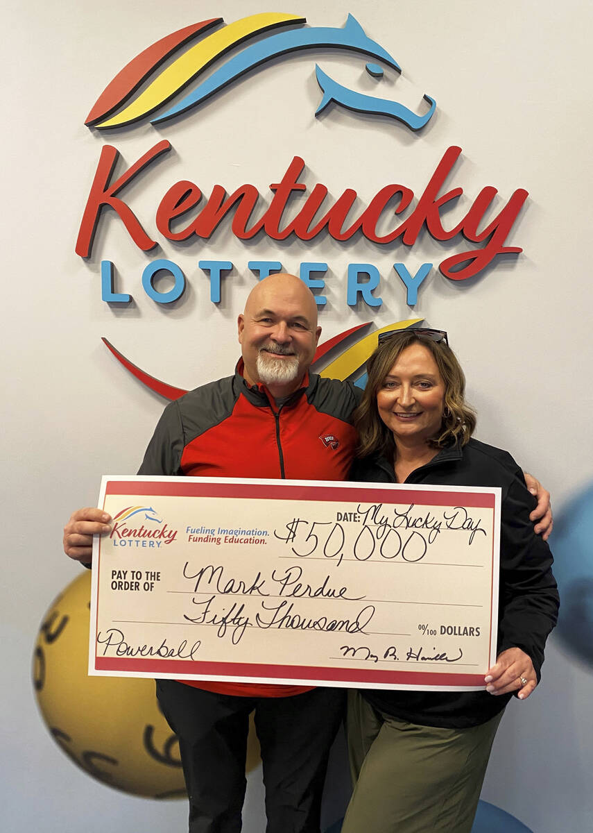 In this recent image provided by Kentucky Lottery, Mark Perdue and his wife pose at the Kentuck ...