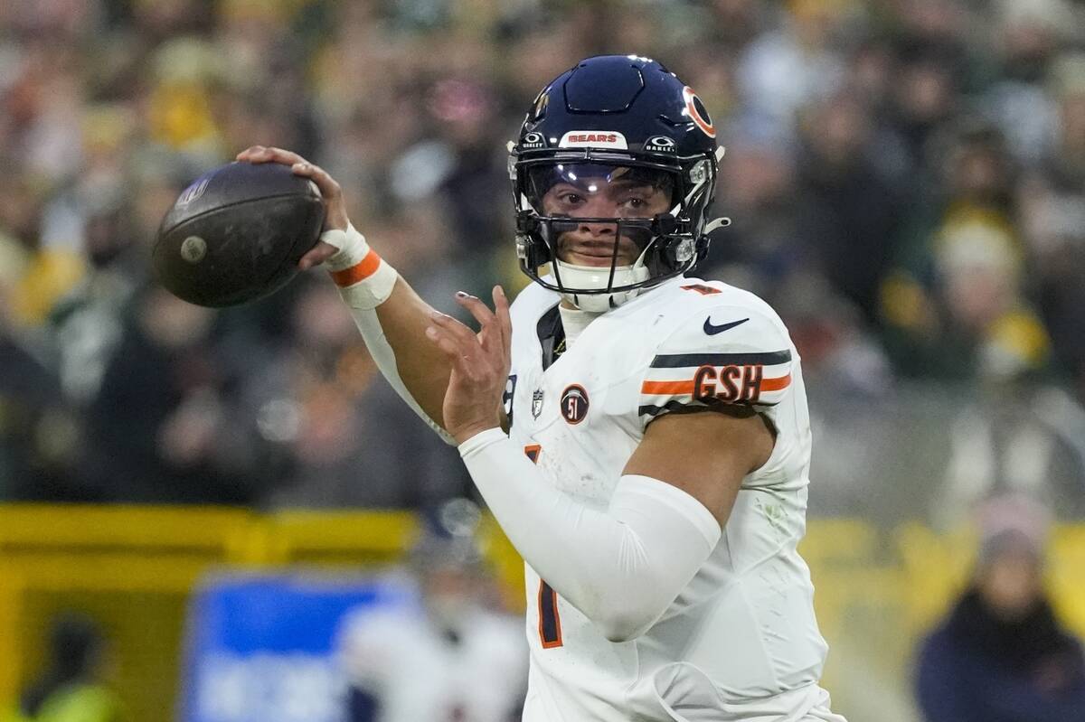 FILE - Chicago Bears' Justin Fields throws during the first half of an NFL football game agains ...