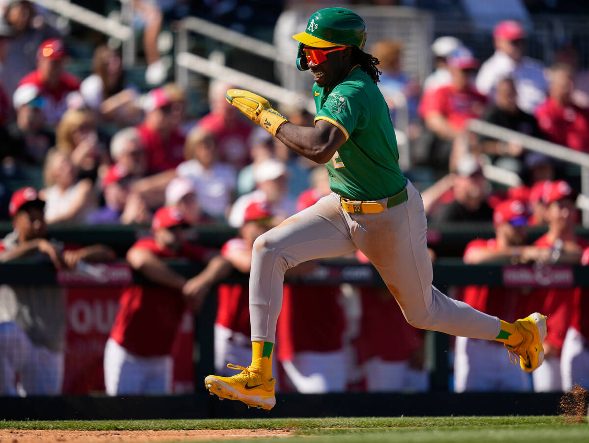 Oakland Athletics' Lawrence Butler runs to score as teammate Tyler Soderstrom grounds out durin ...