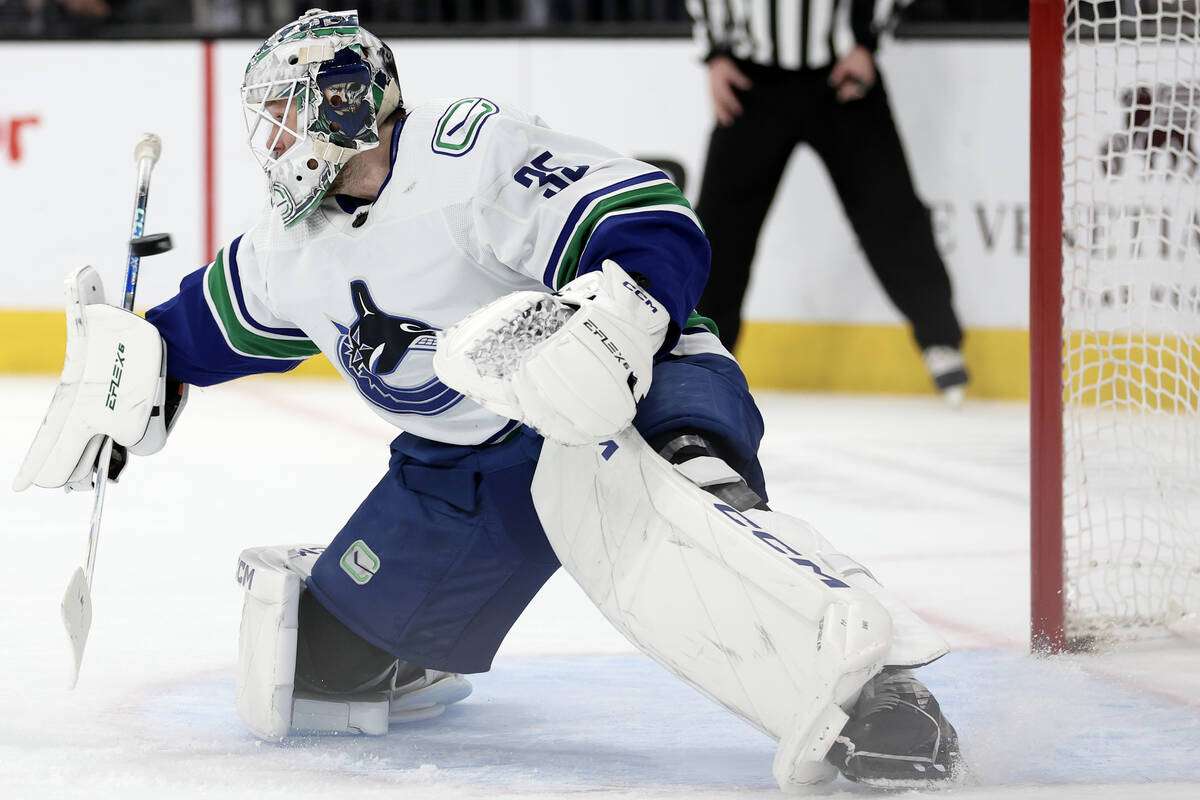 Canucks goaltender Thatcher Demko (35) saves the puck during the first period of an NHL hockey ...