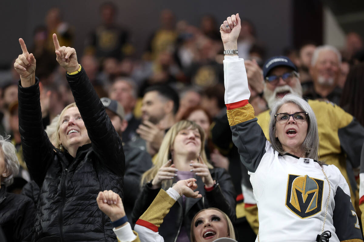 Golden Knights fans celebrate after a score during the second period of an NHL hockey game agai ...