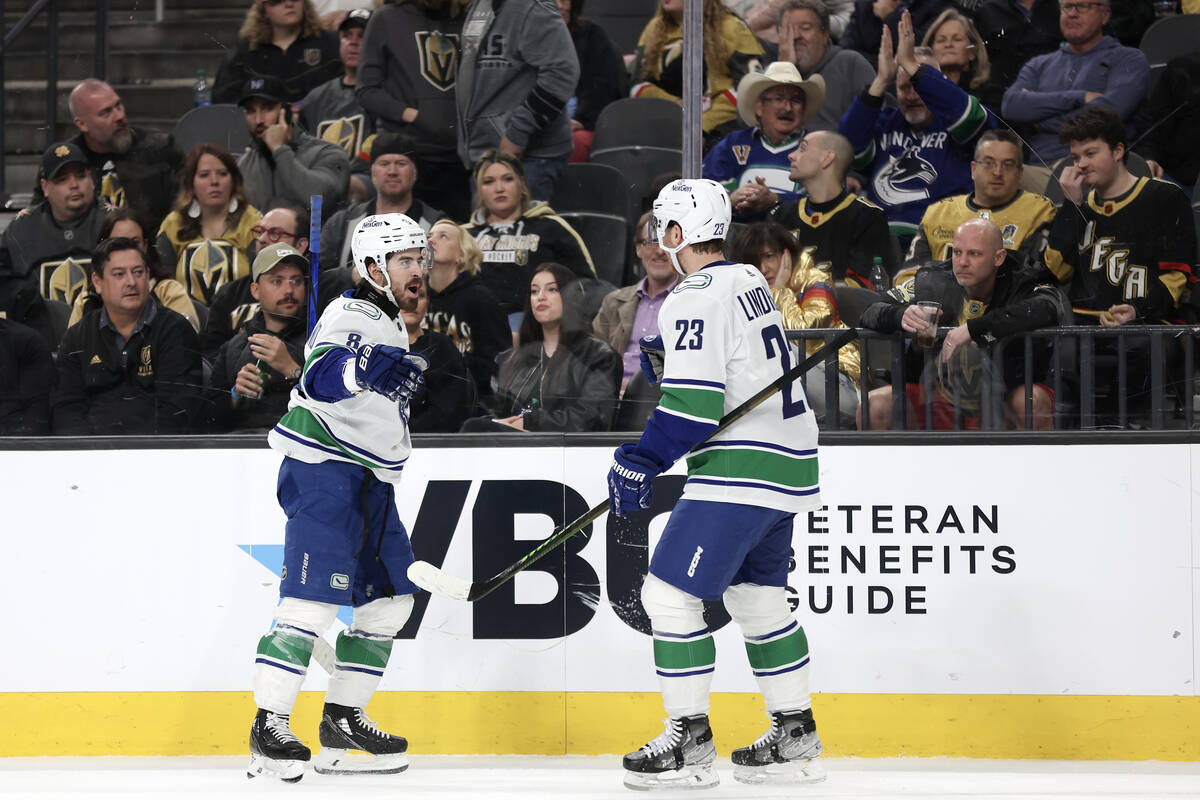 Canucks right wing Conor Garland (8) and center Elias Lindholm (23) celebrate their goal during ...