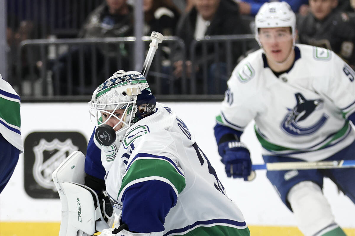 Canucks goaltender Thatcher Demko (35) saves the puck during the third period of an NHL hockey ...