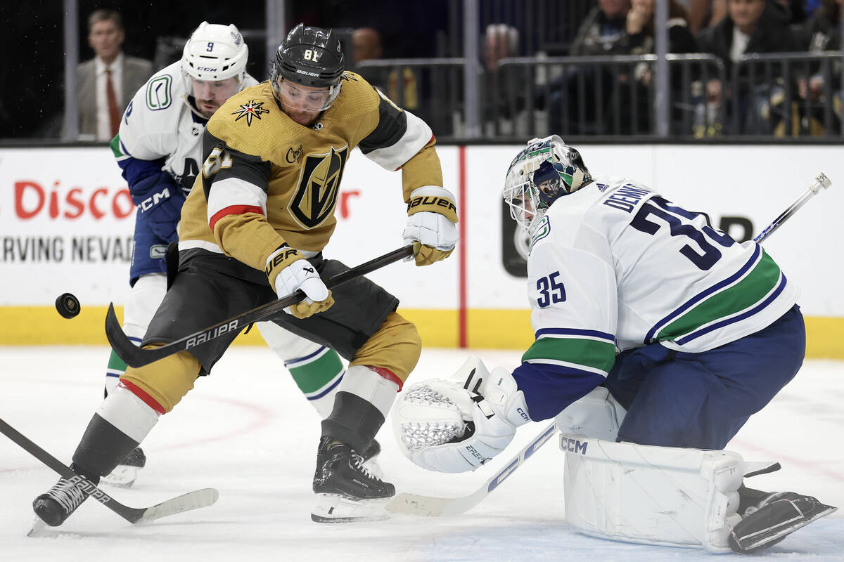 Canucks goaltender Thatcher Demko (35) watches his save while Golden Knights right wing Jonatha ...