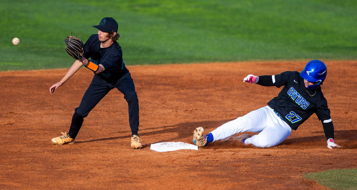 Green Valley Brandon Callahan runner (27) beats the throw to Silverado infielder Tyler Bledsoe ...