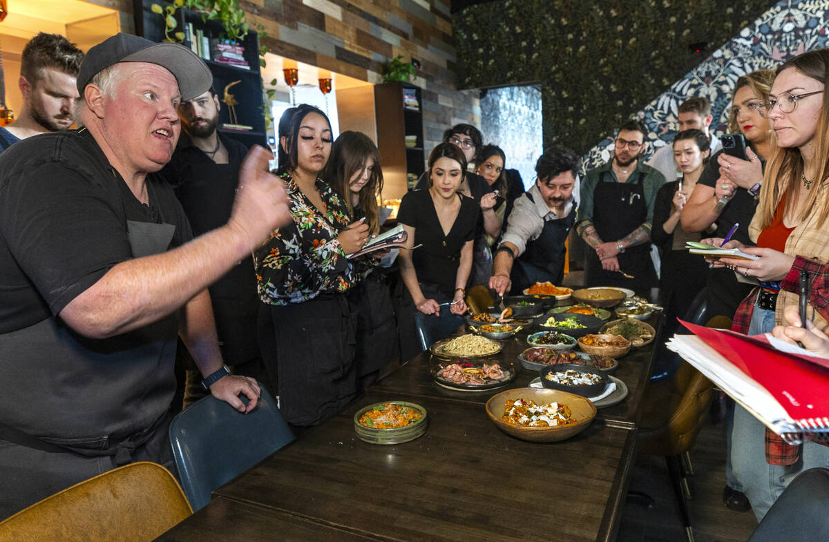 Esther's Kitchen chef/owner James Trees talks with his staff about each of their dishes and the ...