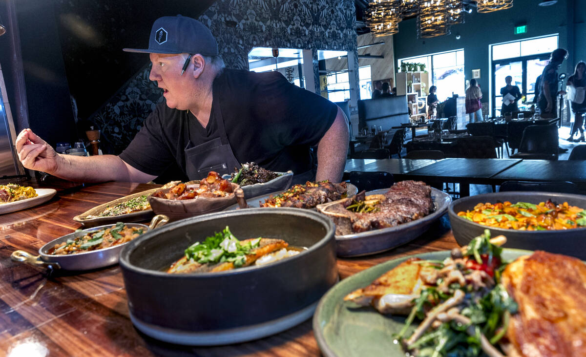 Esther's Kitchen chef/owner James Trees talks with his kitchen staff as they create each of the ...