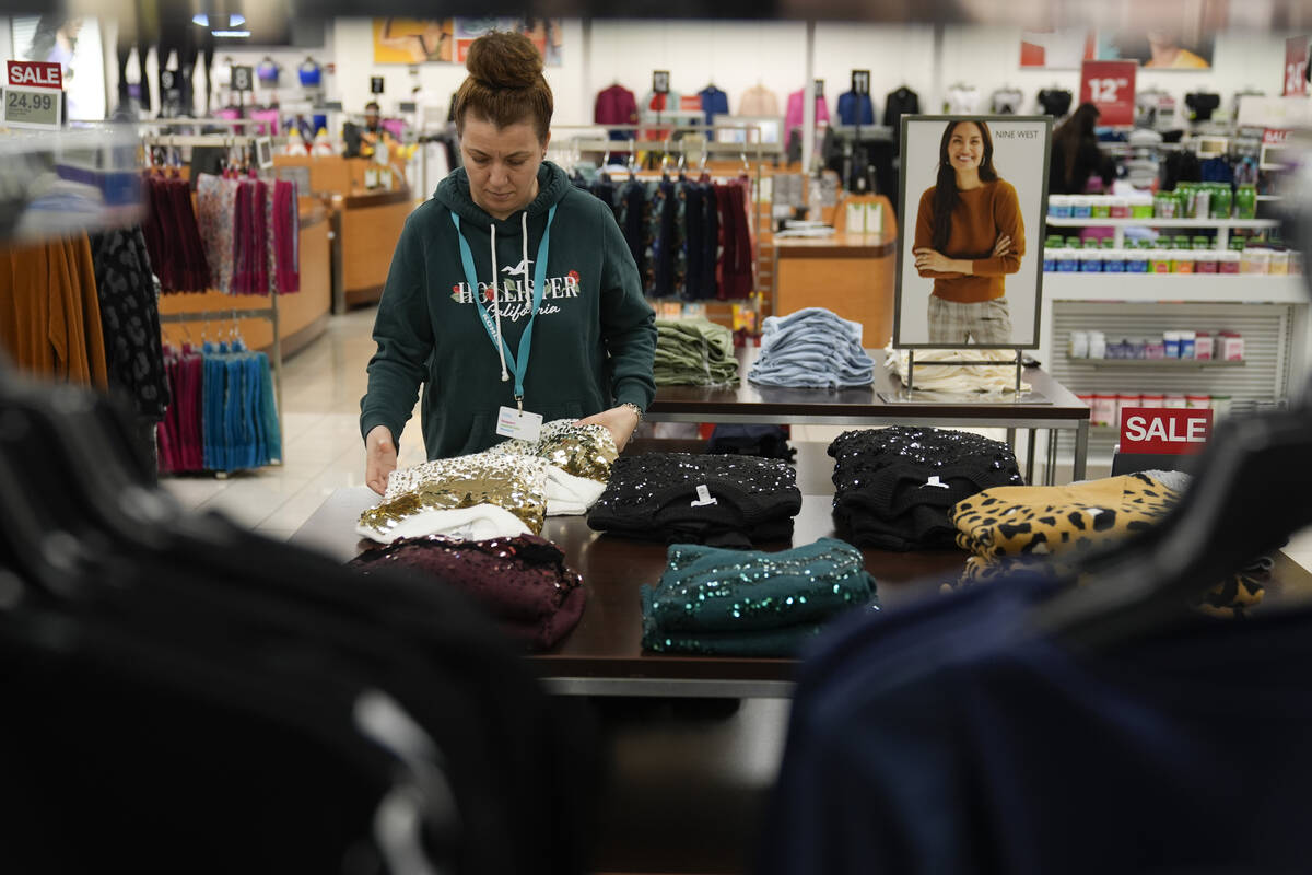 FILE - An employee straightens displays at a Kohl's store in Clifton, N.J., Jan. 26, 2024. On F ...