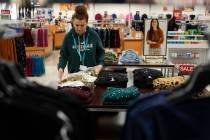 FILE - An employee straightens displays at a Kohl's store in Clifton, N.J., Jan. 26, 2024. On F ...