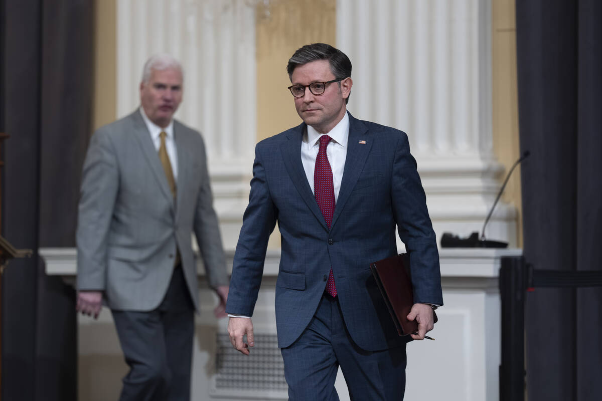 FILE - Speaker of the House Mike Johnson, R-La., right, arrives to meet with reporters at the C ...