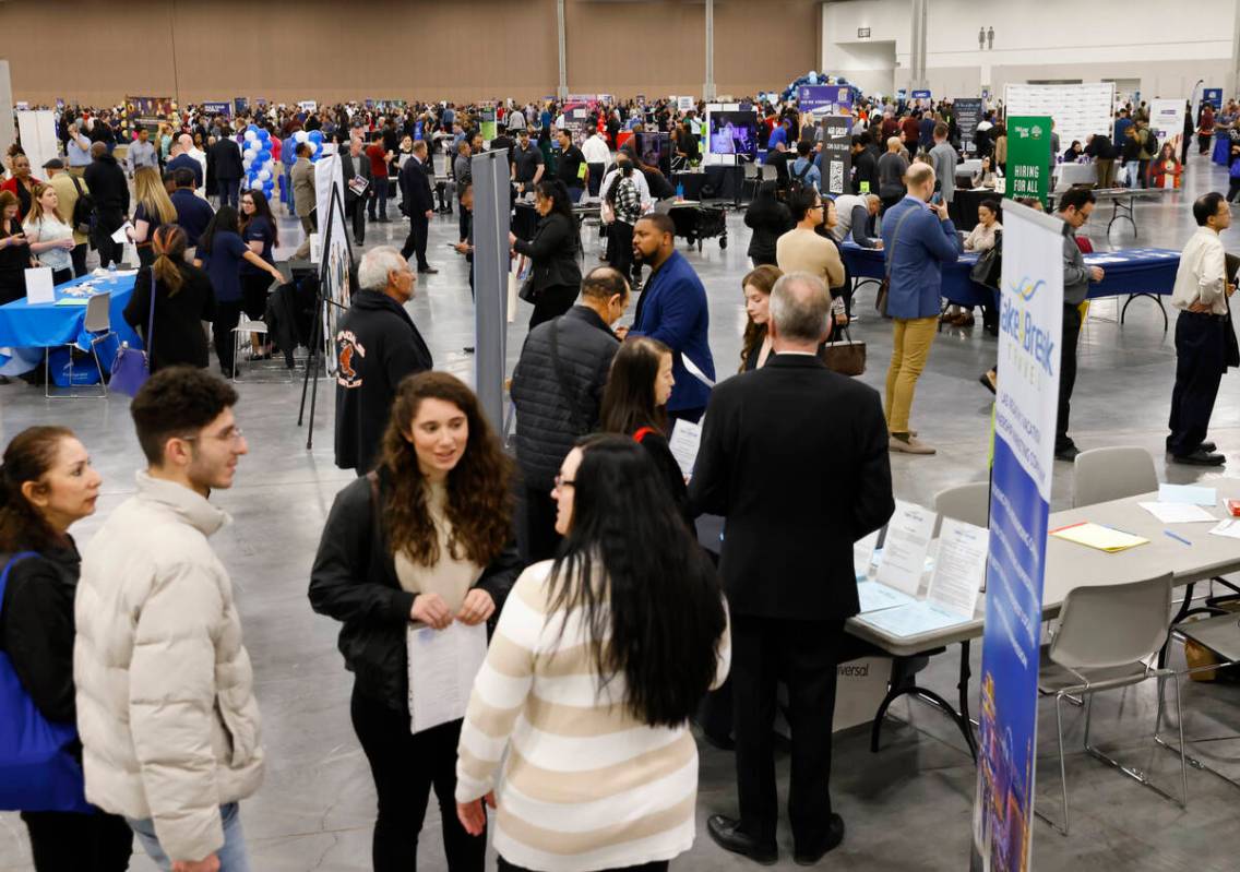 Job seekers visit booths during the annual Spring Job Fair at the Las Vegas Convention Center, ...