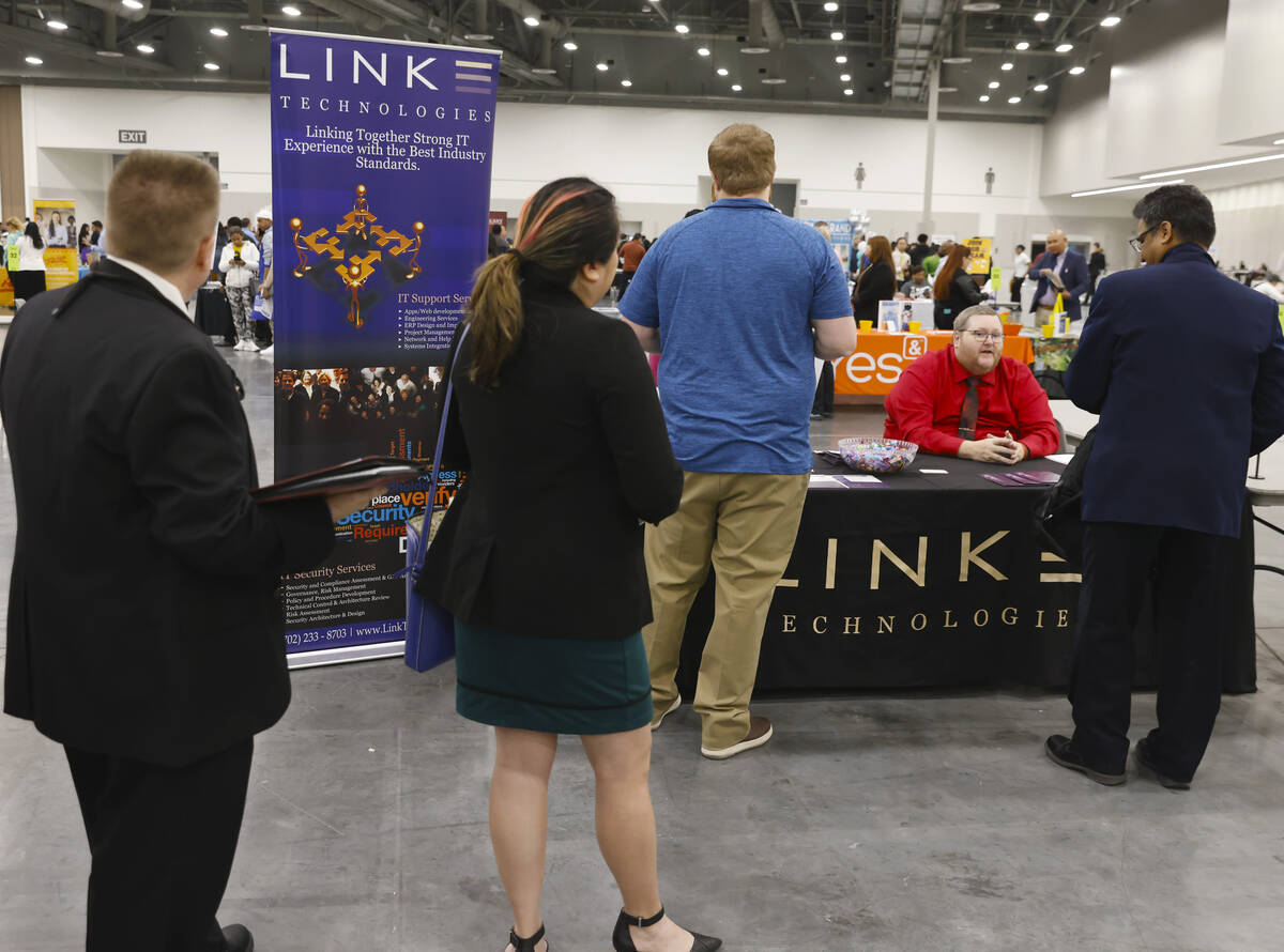 Job seekers line up to talk to recruiters as Patrick Devanny, second right, of Link Technologie ...