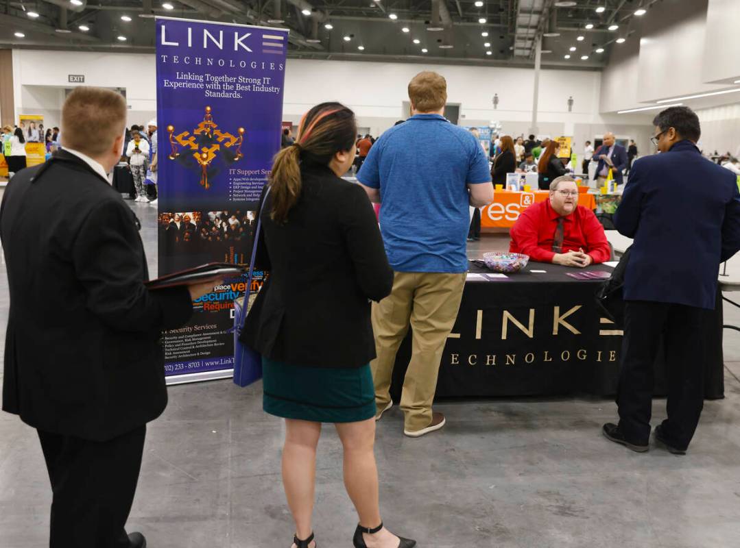 Job seekers line up to talk to recruiters as Patrick Devanny, second right, of Link Technologie ...