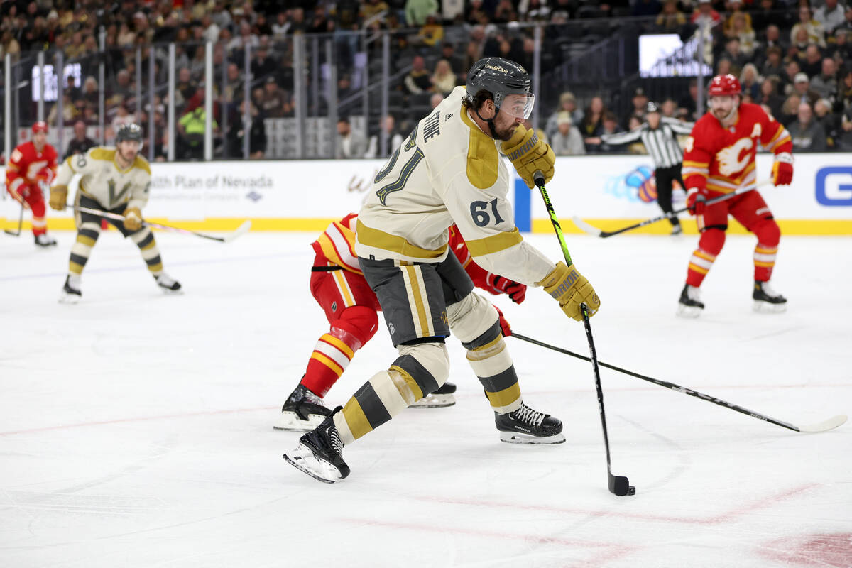 Golden Knights right wing Mark Stone (61) winds up to shoot against the Flames during the first ...