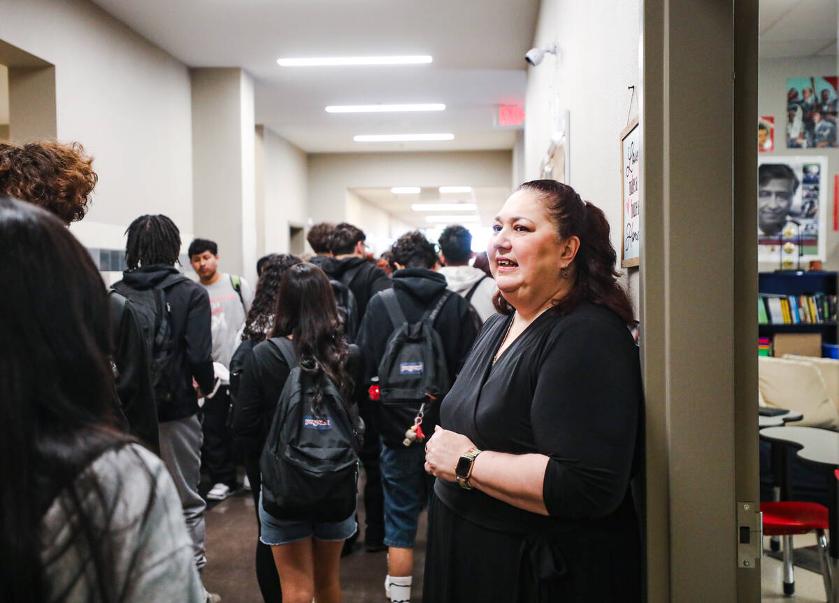 English teacher Tillie Torres greets students as the head to classes at Mater Academy in Las Ve ...