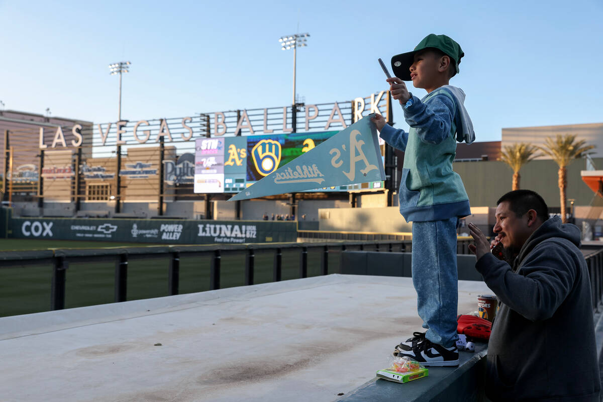 A young fan asks for autographs from the Oakland Athletics during a Major League Baseball sprin ...