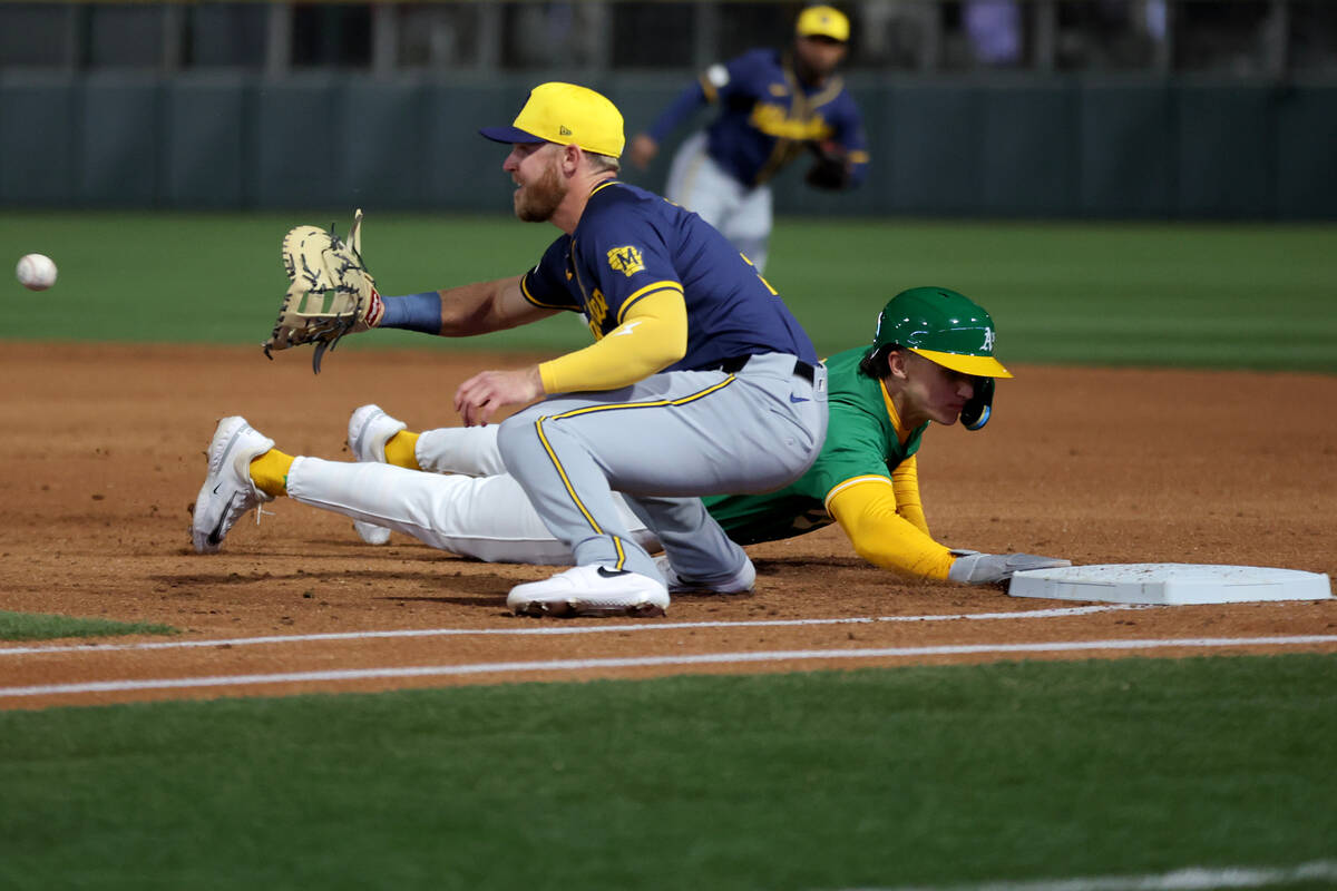 Oakland Athletics second baseman Zack Gelof (20) slides into first base after attempting to ste ...