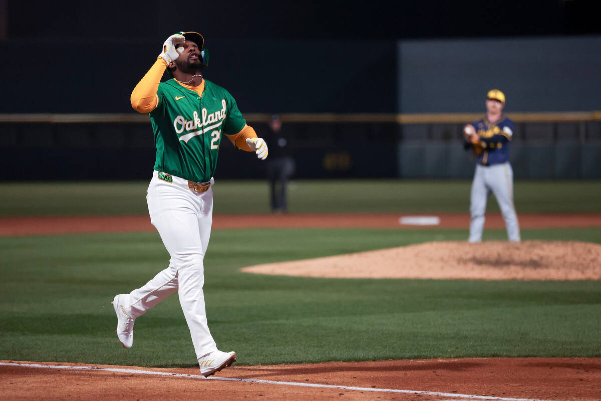 Oakland Athletics outfielder Miguel Andujar (22) gestures to the sky after hitting a home run d ...