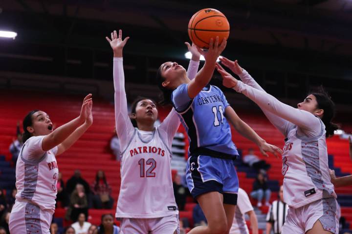 Centenial’s Danae Powell (11) goes in for a layup around Liberty’s Daisha Peavy ( ...