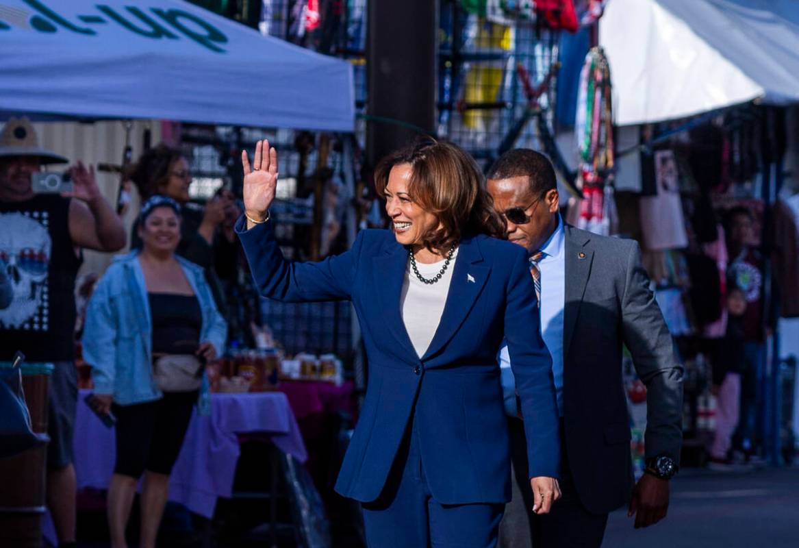 Vice President Kamala Harris waves to customers and vendors as she makes a stop to chat with pe ...