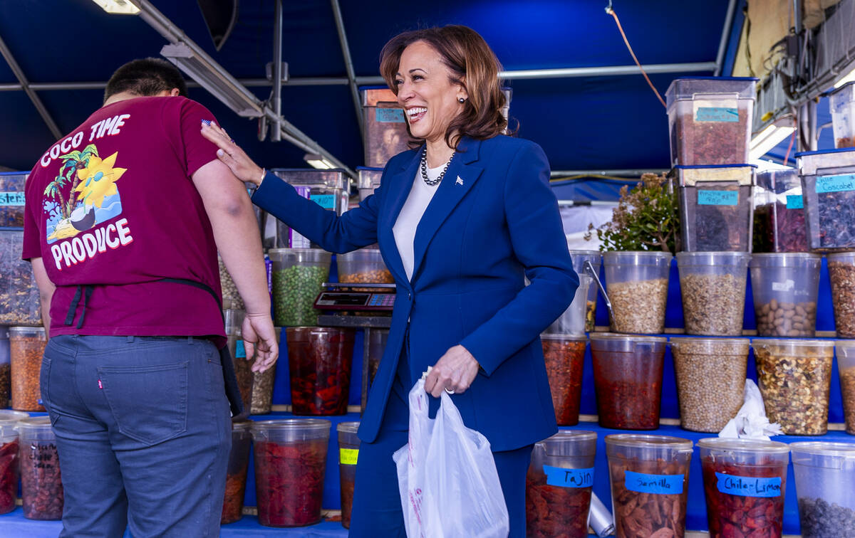 Vice President Kamala Harris thanks a vendor after making a purchase while on a stop to chat w ...