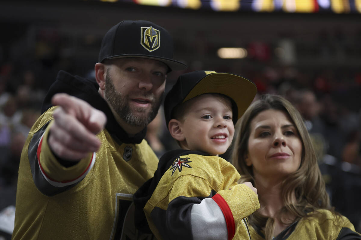 Golden Knights fans Kevin Hildner, left, Amberlee Hildner and their son Liam, 5, of Las Vegas, ...