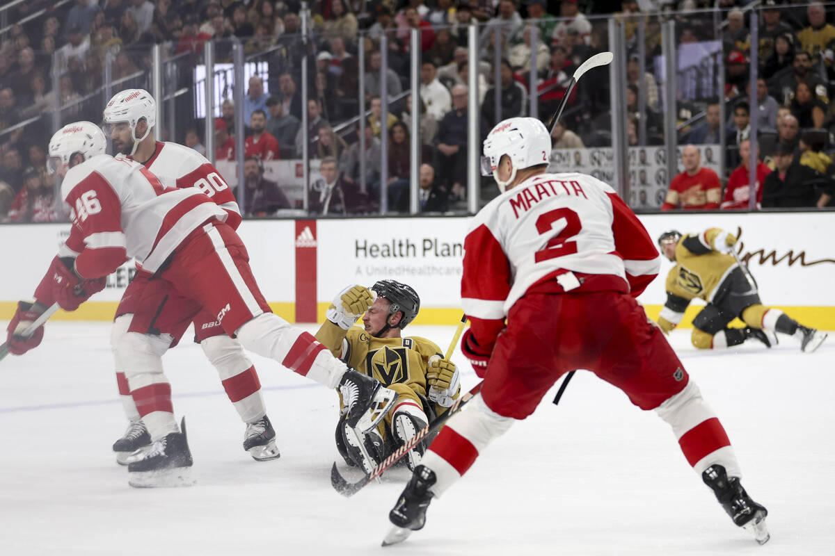 Golden Knights center Jack Eichel (9) falls to the ice after losing the puck to the Red Wings d ...
