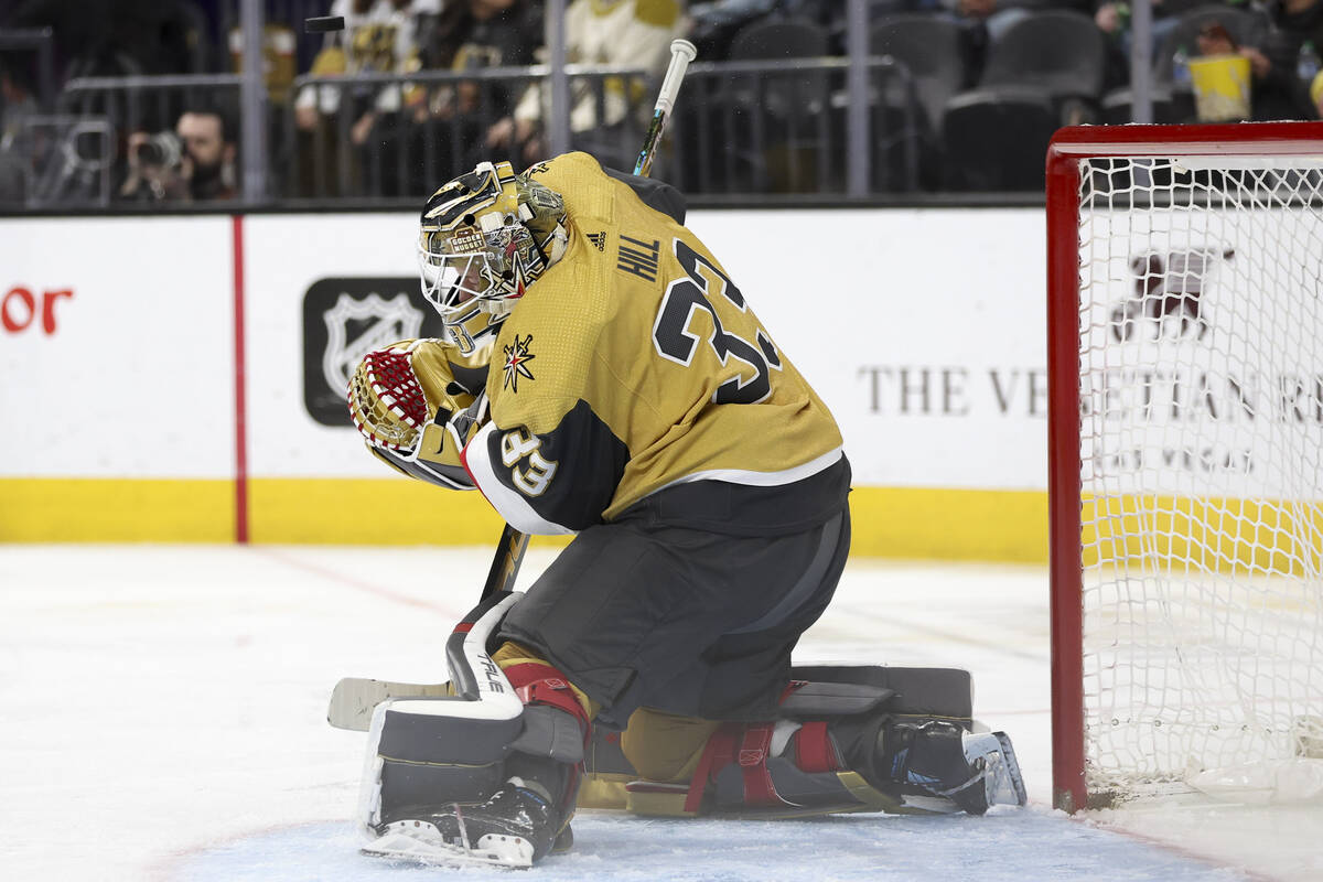 Golden Knights goaltender Adin Hill (33) saves the puck during the second period of an NHL hock ...