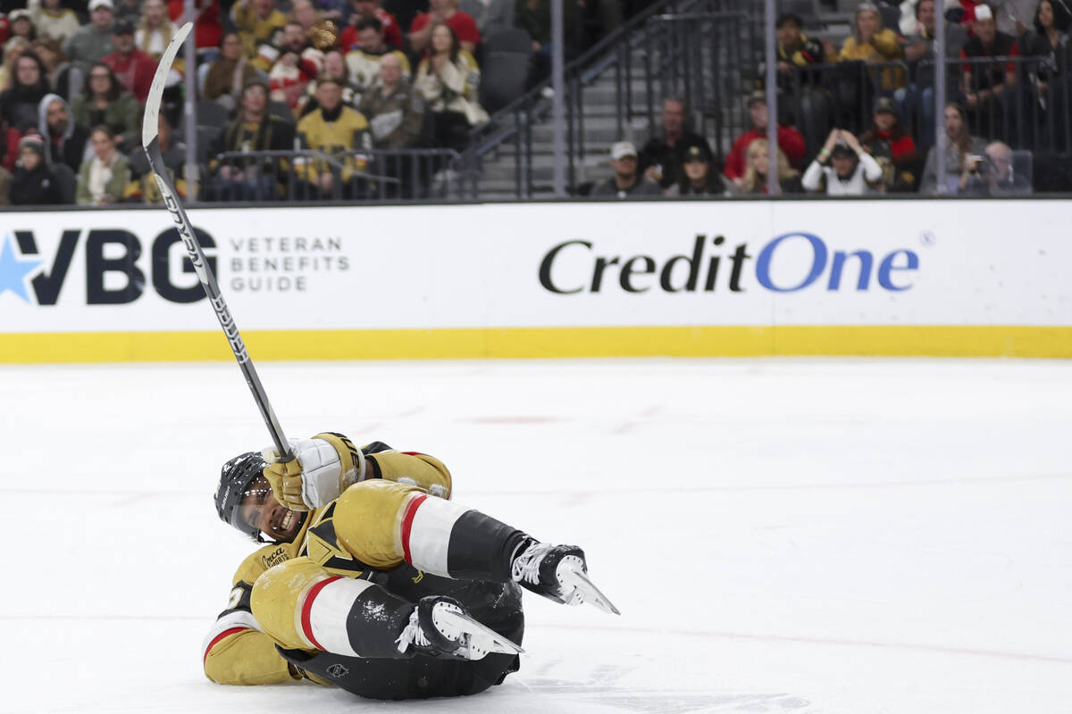 Golden Knights right wing Keegan Kolesar (55) grimaces while he falls to the ice during the thi ...