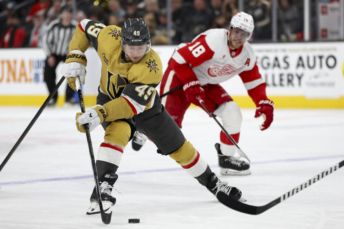 Golden Knights center Ivan Barbashev (49) takes the puck up the ice ahead of Red Wings center A ...