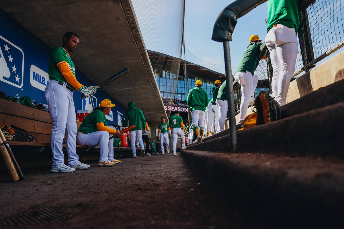 Oakland A’s players high five as they make their way into the dug out during a Big Leagu ...