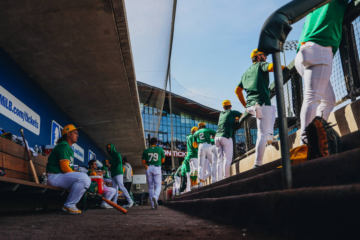 Oakland A’s players high five as they make their way into the dug out during a Big Leagu ...
