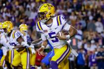 LSU quarterback Jayden Daniels (5) runs for a touchdown against Florida during the first half o ...