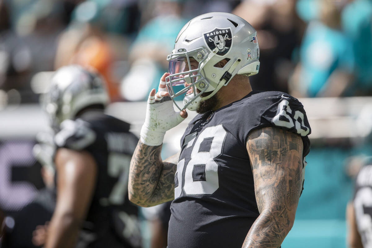 Raiders center Andre James (68) adjusts his helmet before an NFL game against the Miami Dolphin ...