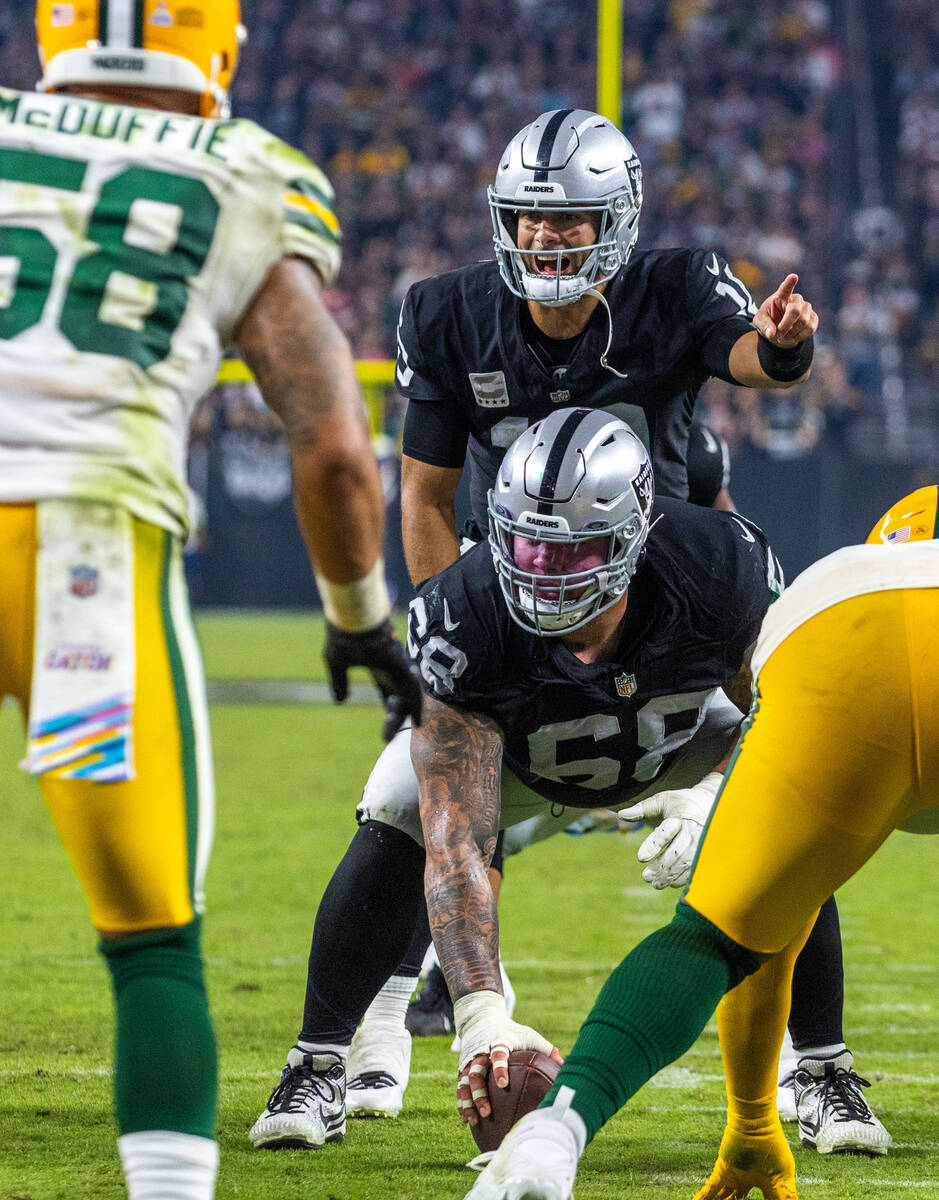 Raiders quarterback Jimmy Garoppolo (10) calls a play awaiting a hike from center Andre James ( ...