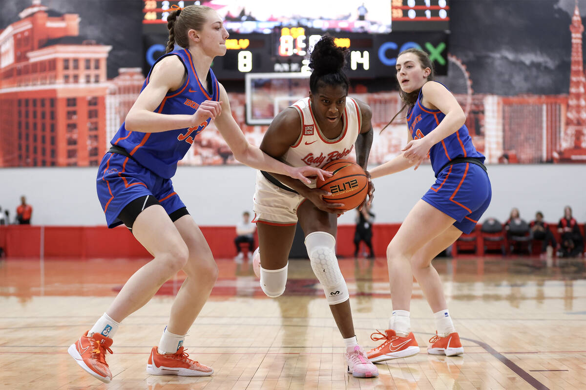 UNLV Lady Rebels center Desi-Rae Young (23) drives between Boise State Broncos forward Abby Mus ...