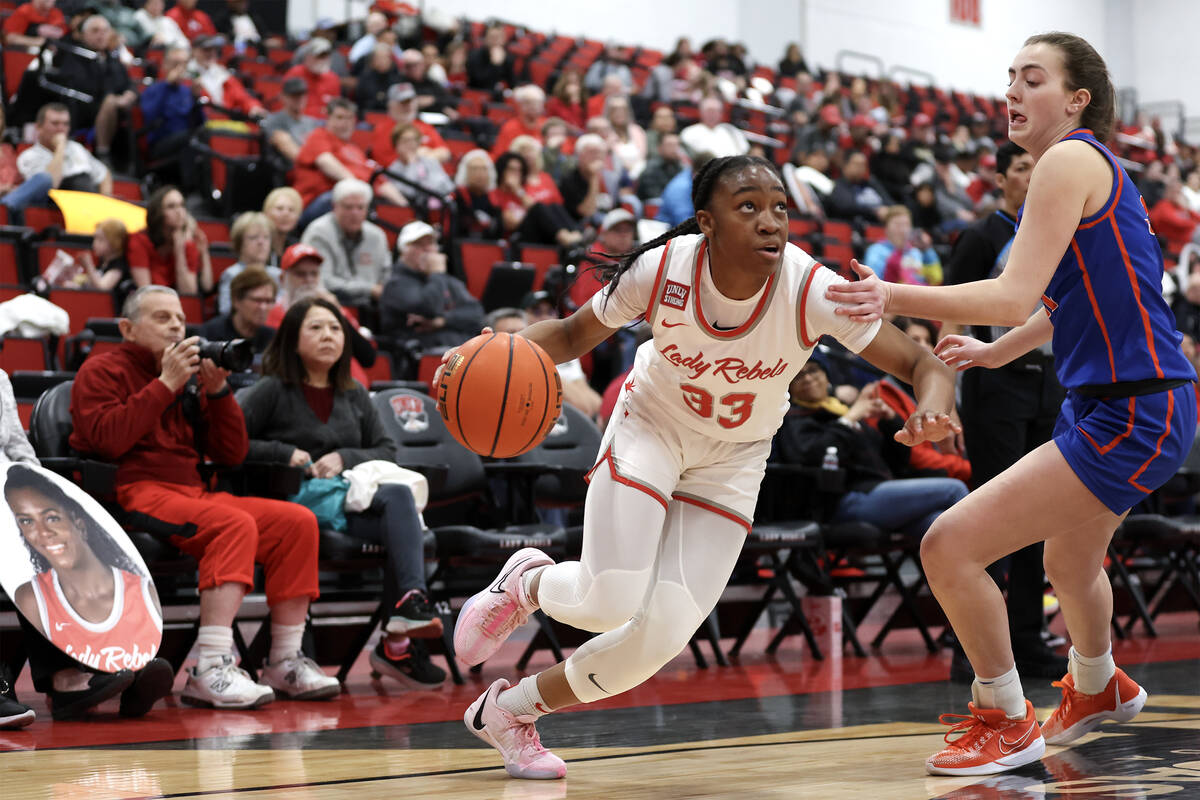 UNLV Lady Rebels guard Amarachi Kimpson (33) drives around Boise State Broncos forward Trista H ...