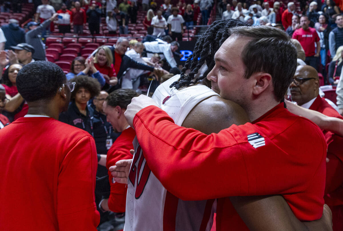 UNLV forward Keylan Boone (20) hugs head coach Kevin Kruger after defeating the San Diego State ...