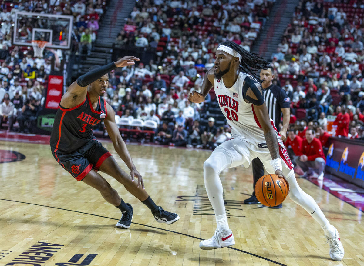 UNLV forward Keylan Boone (20) looks to drive past San Diego State Aztecs guard Micah Parrish ( ...