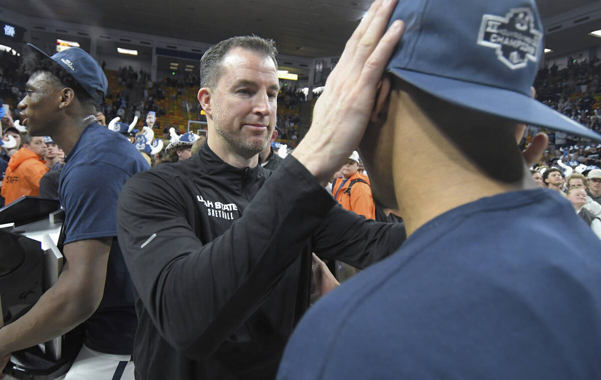 Utah State coach Danny Sprinkle talks to guard Darius Brown II after the team's win over New Me ...