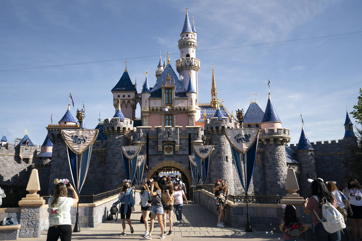 Visitors pass through Disneyland in Anaheim, Calif., April 30, 2021. Disney is seeking approva ...