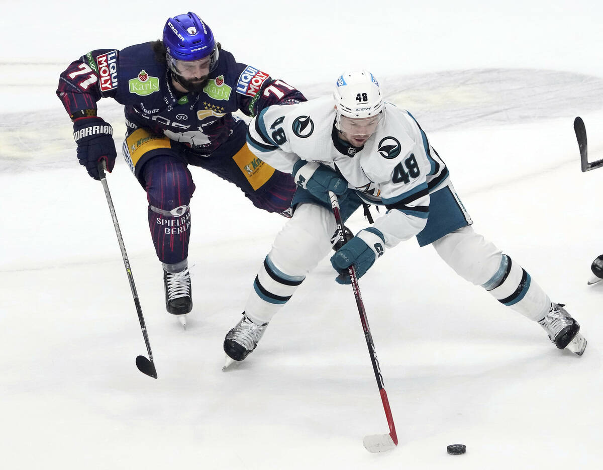 San Jose's Tomas Hertl, right, and Berlin's Julian Melchiori, left, challenge for the puck ...