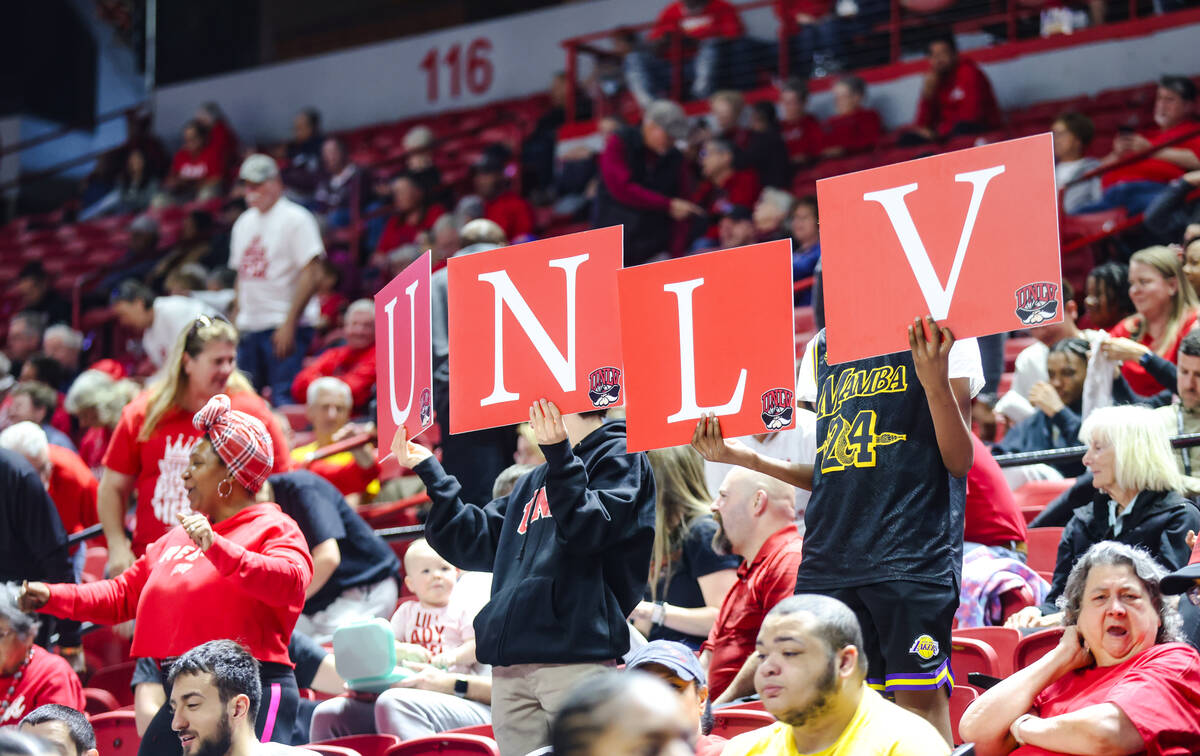 Supporters hold a sign for the UNLV Lady Rebels in their game against Fresno State during the M ...