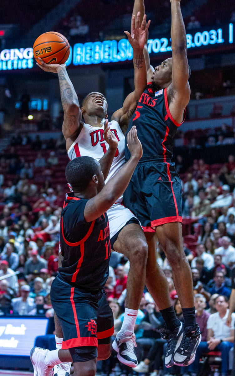 UNLV guard Luis Rodriguez (15) battles up to get off a shot against San Diego State Aztecs guar ...