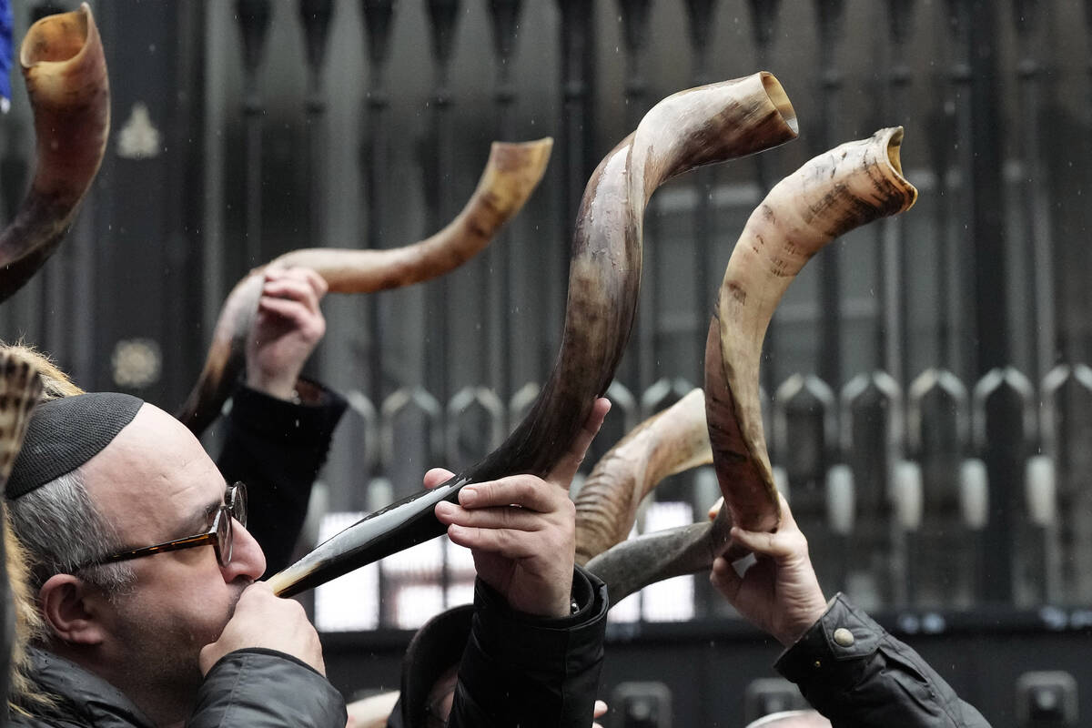 Jewish people and sympathisers blow shofars (ram's horns of spiritual significance) and whistle ...