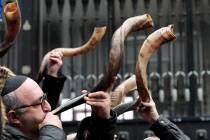 Jewish people and sympathisers blow shofars (ram's horns of spiritual significance) and whistle ...