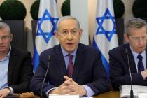Israeli Prime Minister Benjamin Netanyahu, middle, chairs a Cabinet meeting at the Kirya, which ...