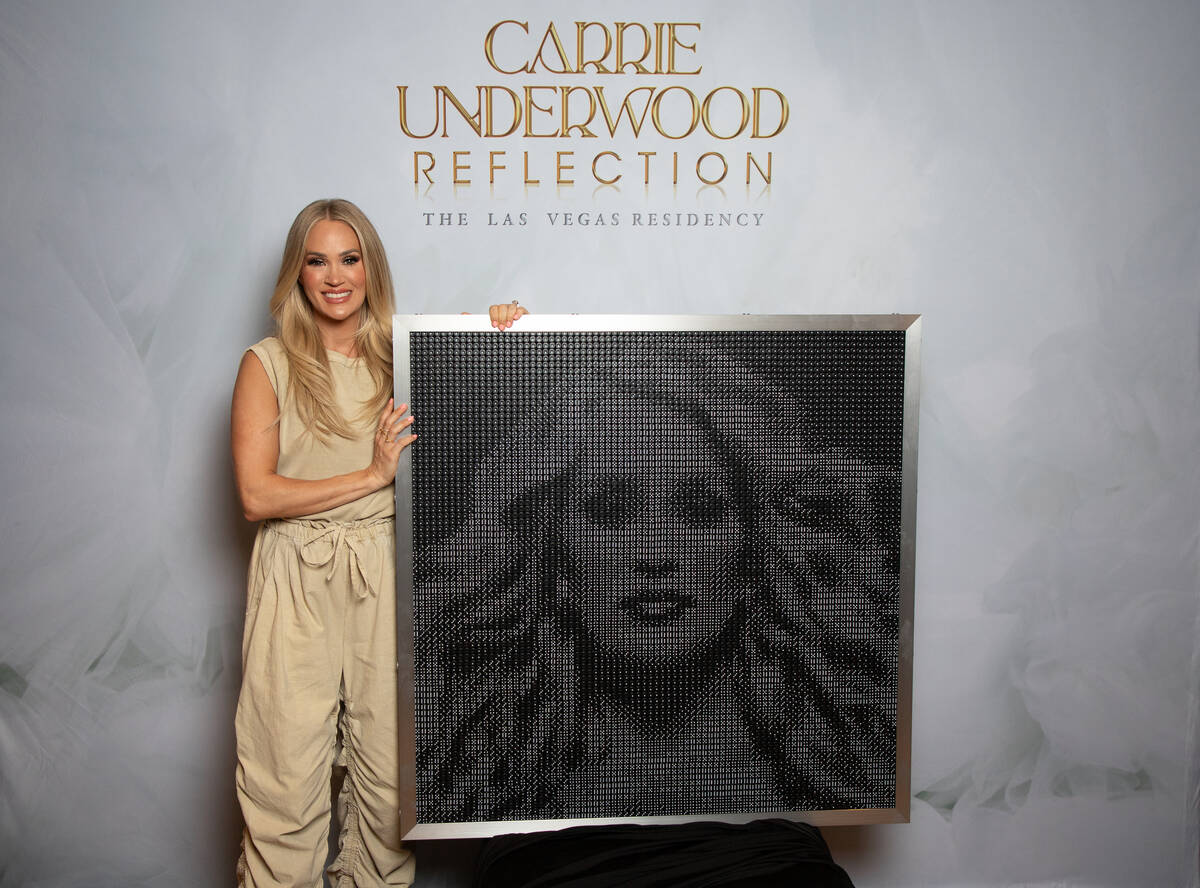 Carrie Underwood is shown with the dice clock AEG Presents presented to her for her 41st birthd ...